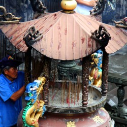 Man putting an incense stick for the gods